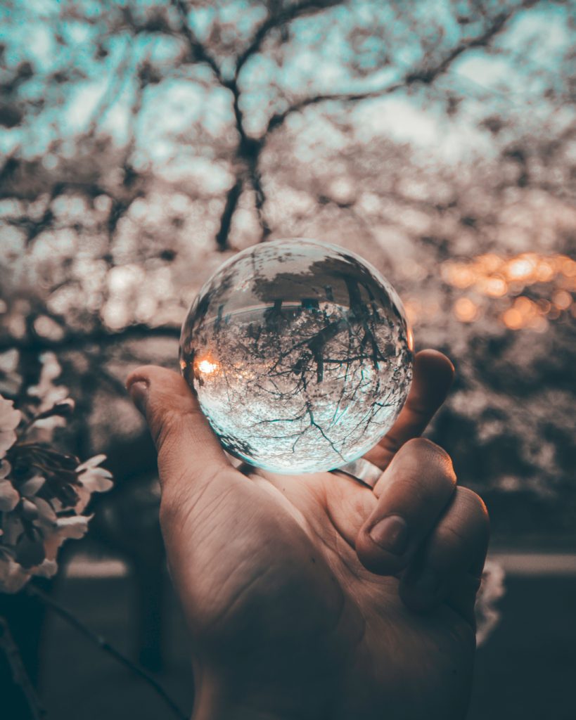 A person holding a crystal ball in their hand.
