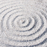 A white sand circle with a spiral pattern.